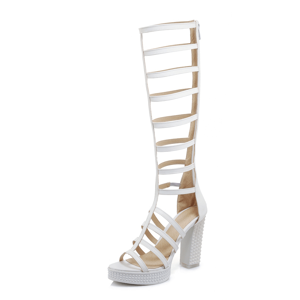Women's white knee-high gladiator sandals with strappy design and chunky heel, perfect for summer styling.