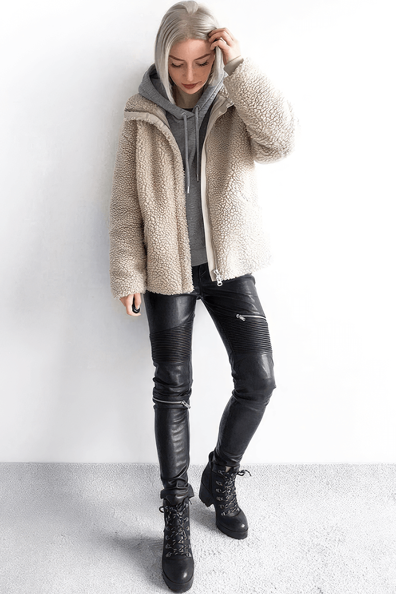 Stylish woman in cozy beige jacket and PU leather pants, perfect for trendy rock outfits and casual outings.