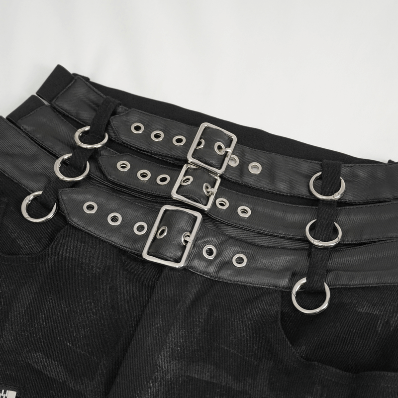 Close-up of multi-buckles on women's punk high-waisted ripped fitted pants, showcasing edgy fashion details.