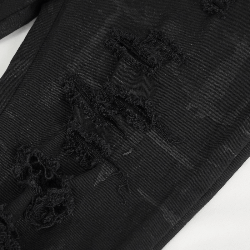 Close-up of black high-waisted ripped punk pants showcasing edgy rips and distressed texture.