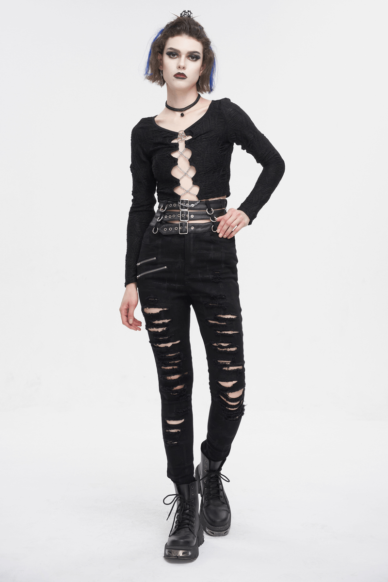 Edgy woman in black high-waisted ripped pants and stylish top, showcasing punk fashion with multi-buckles and combat boots.