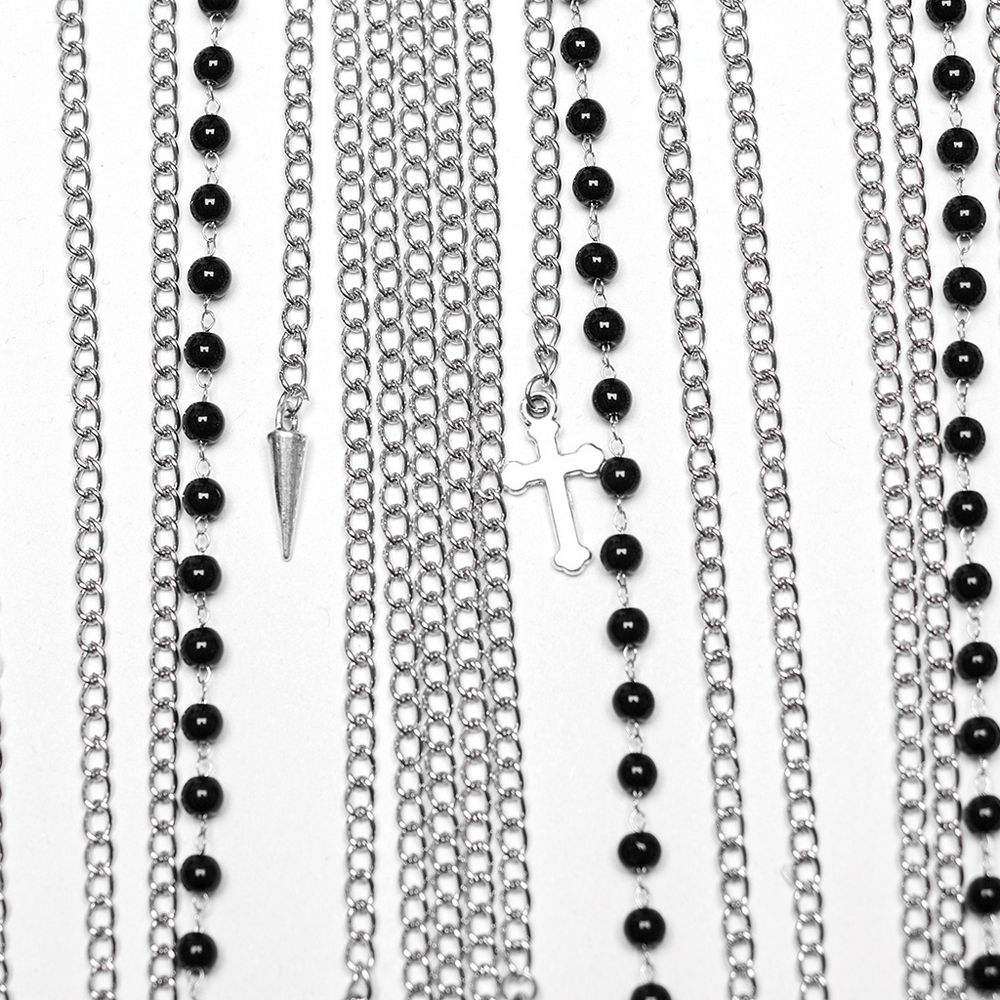 Multilayered chains with black beads, spike, and cross pendants from women's punk body harness.