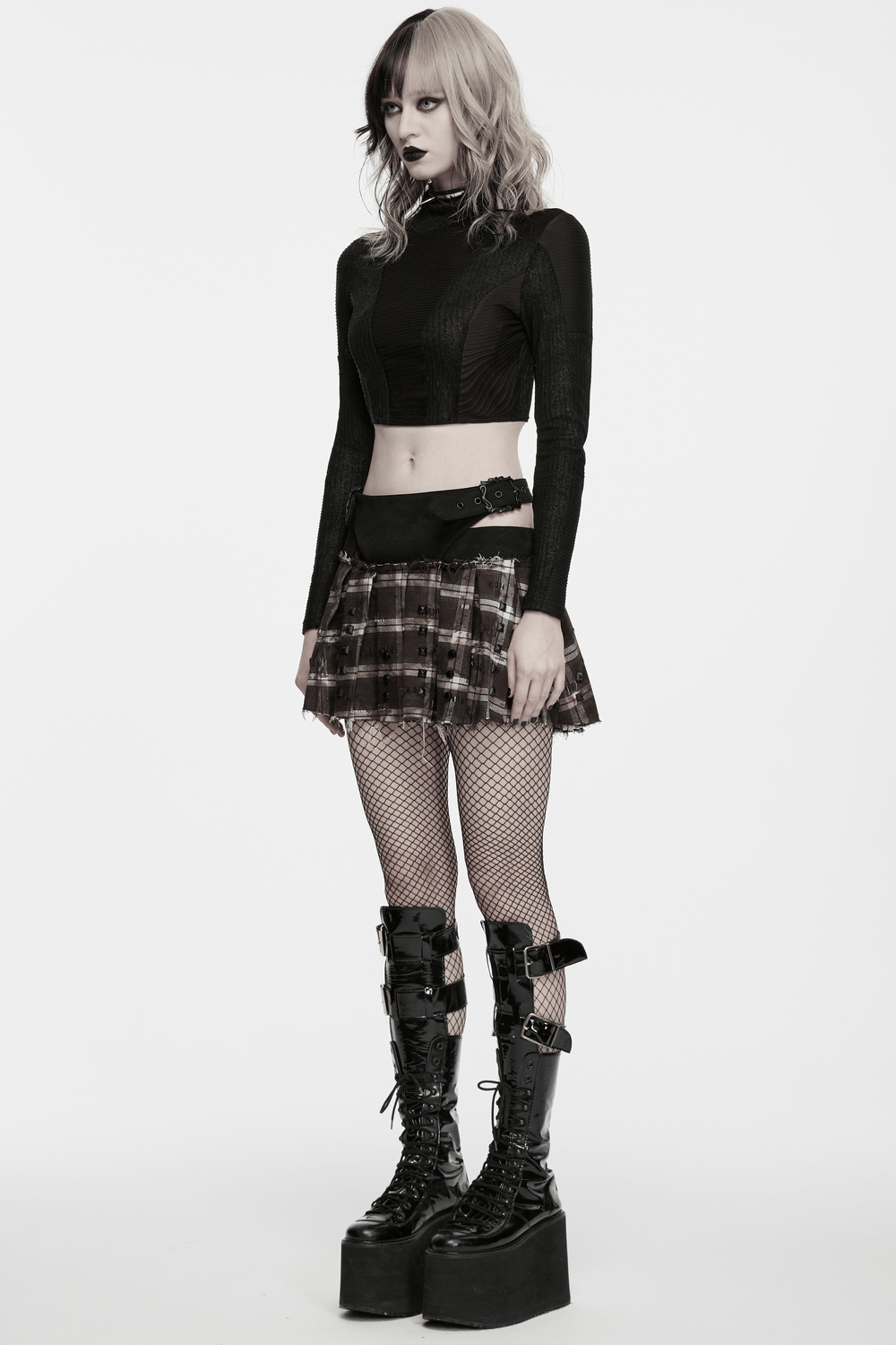 Women's Punk Plaid Mini Skirt with Studded Belt worn with a cropped top and knee-high platform boots.