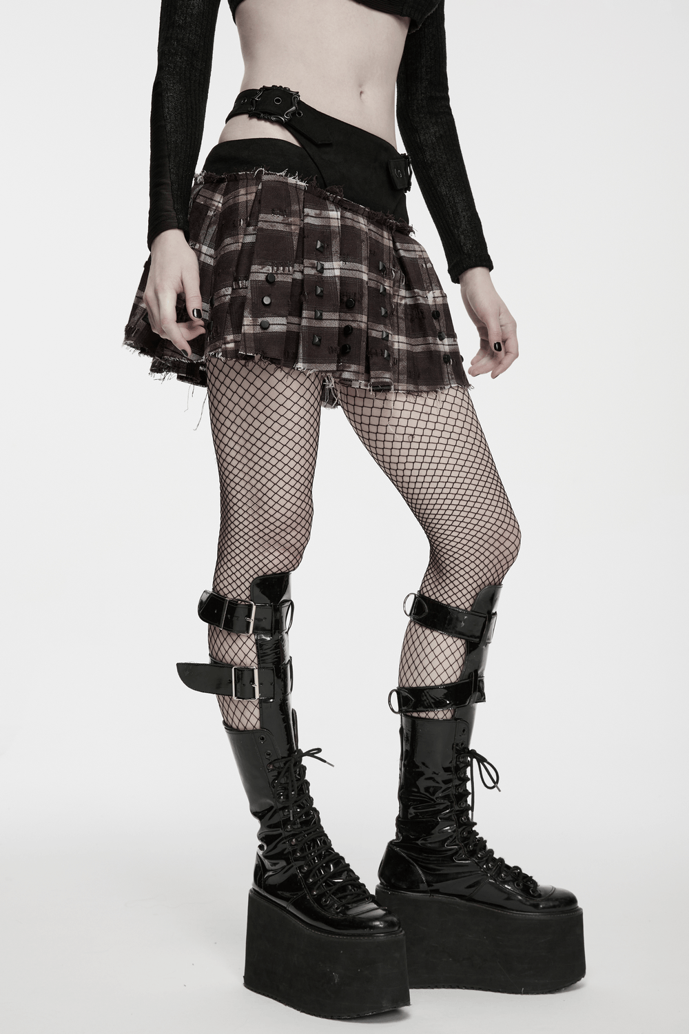 Women's Punk Plaid Mini Skirt with Studded Belt paired with fishnet tights and edgy platform boots.
