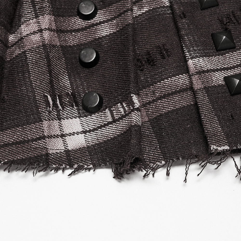 Close-up of Women's Punk Plaid Mini Skirt with Studded Belt showing black studs and frayed edges on plaid fabric.
