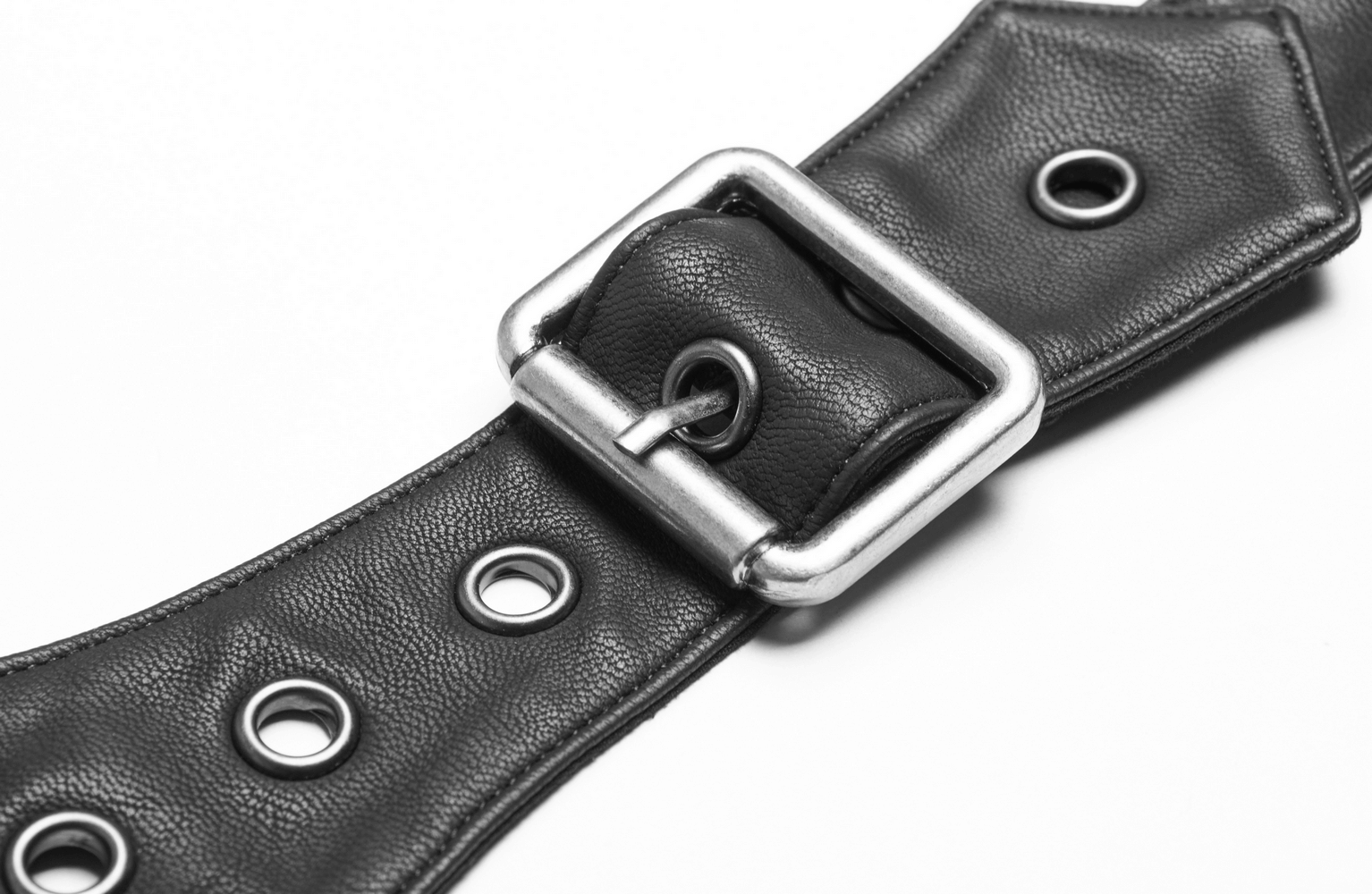 Close-up of black PU leather punk belt featuring eyelets and a silver buckle detail.