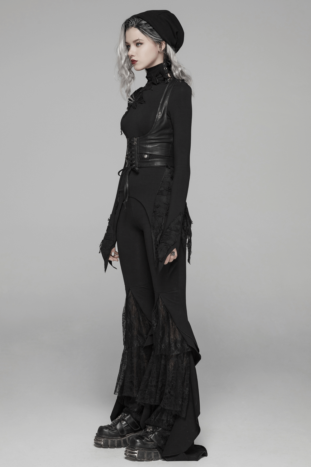 Edgy woman in black PU leather corset and stylish outfit, showcasing punk fashion with fitted silhouette and lace detail.