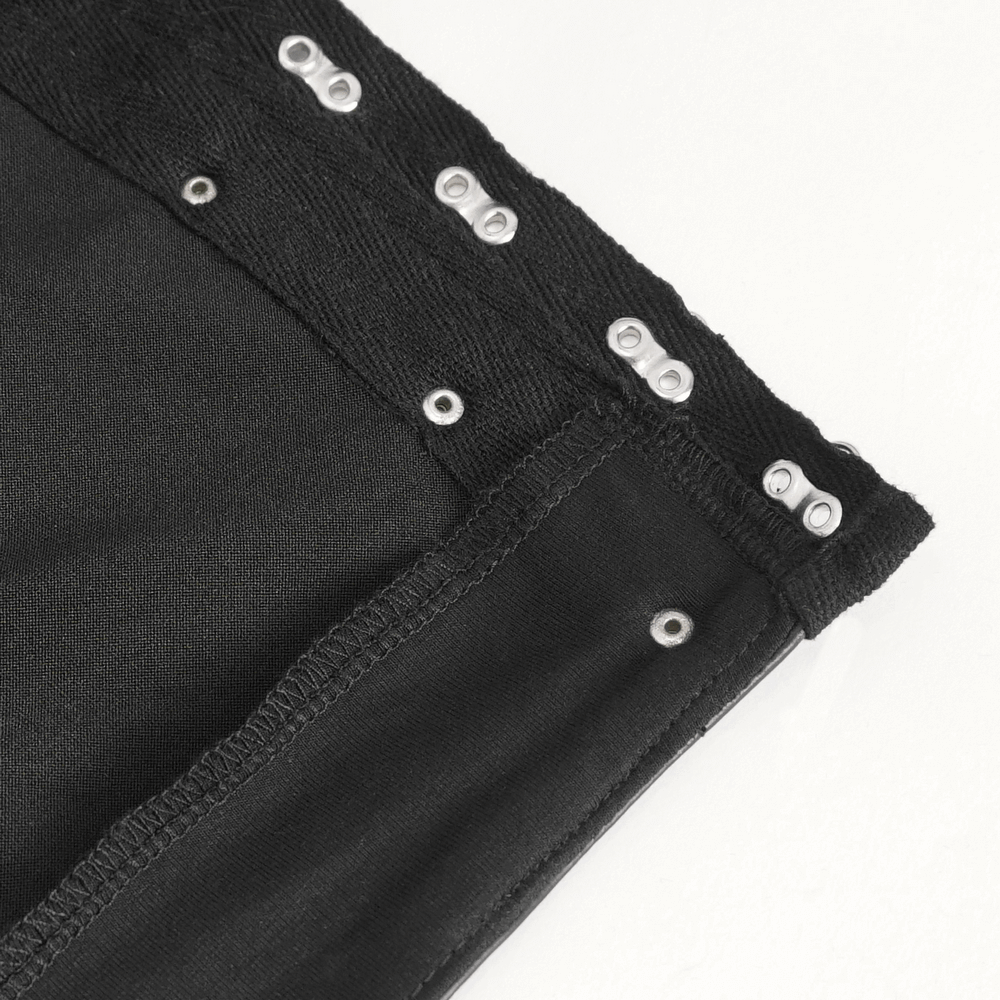 Close-up of the waistband detailing of women's punk faux leather pants with metal snaps.