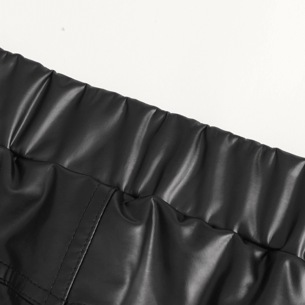Close-up of the waistband of women's punk slim faux leather pants with a sleek, shiny finish.