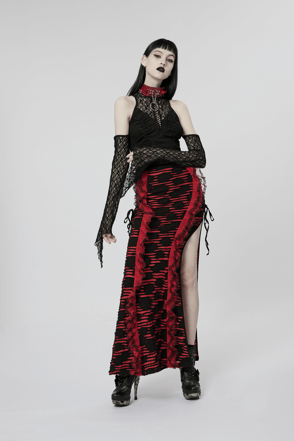 Gothic woman in black and red outfit, showcasing a daring fashion statement with punk flair.