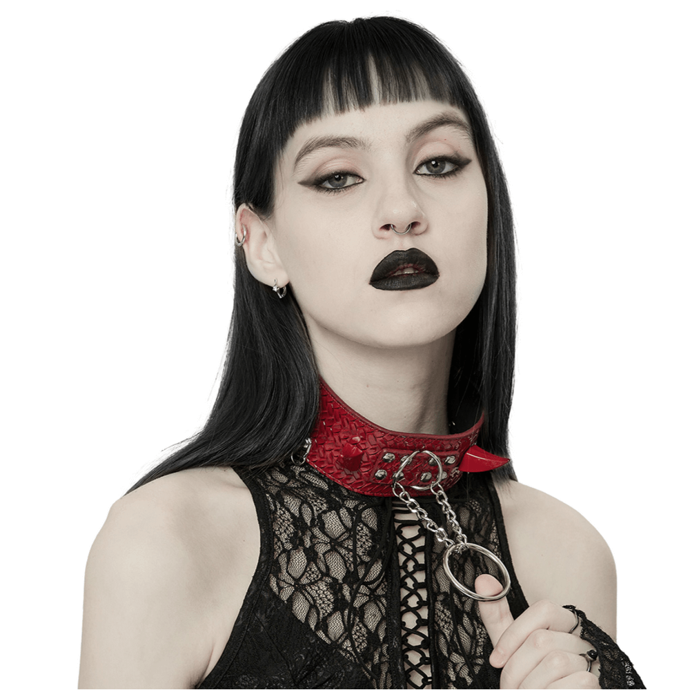 Edgy woman wearing a red Python Grain choker with metal chains, embodying punk rebellious style.
