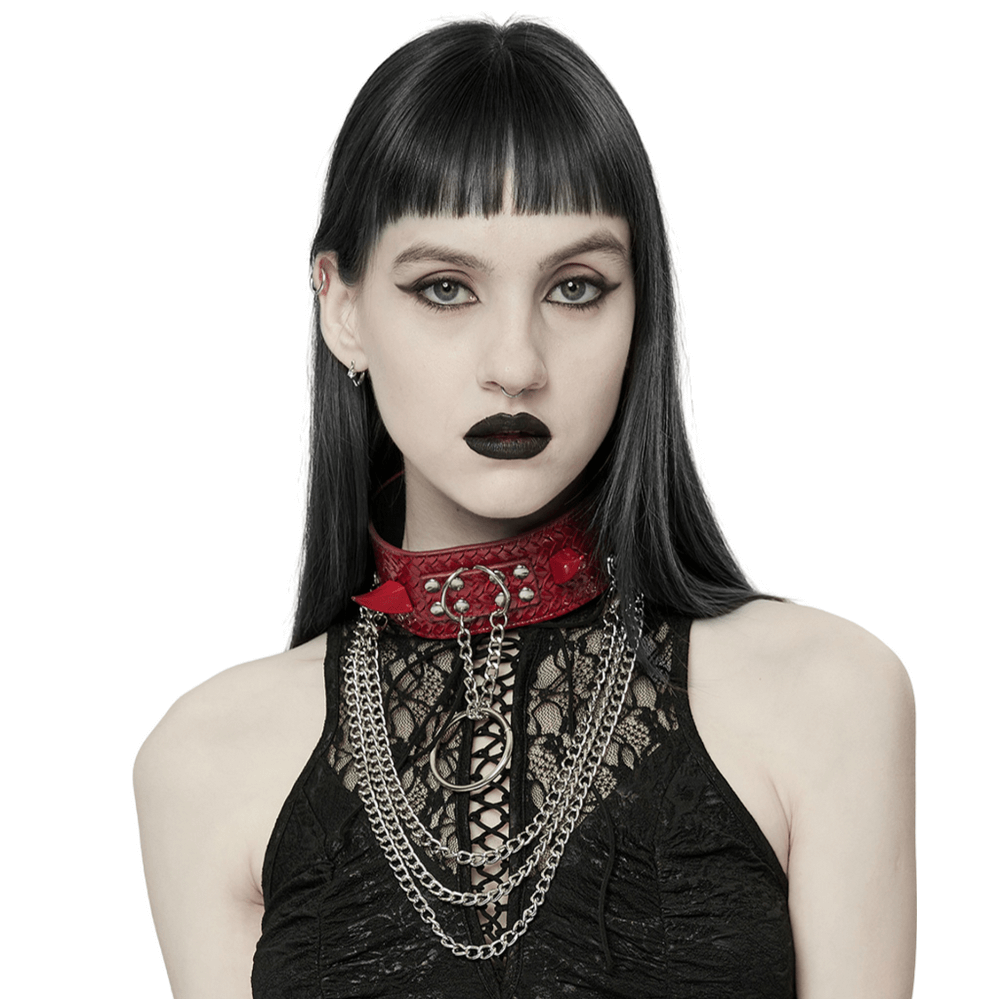 Model showcasing a bold red Python Grain choker with metal chains and spikes for an edgy punk look.