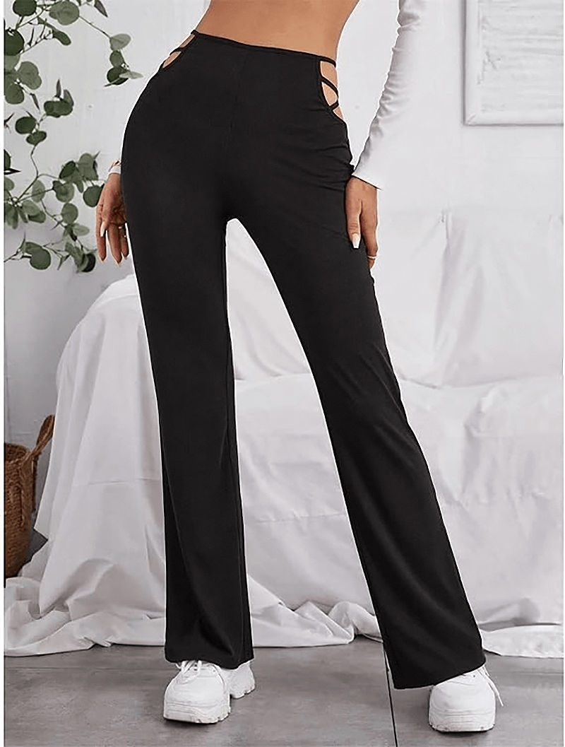 Women's high waist black pants with hollow-out details capturing classy and sexy alternative fashion look.