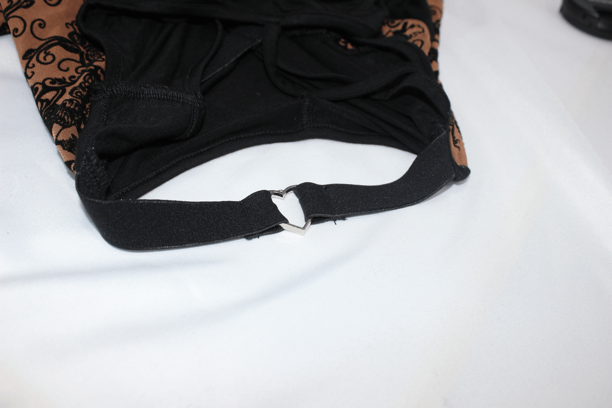 Close-up of the strap detail featuring a metal heart on a brown gothic vintage dress.