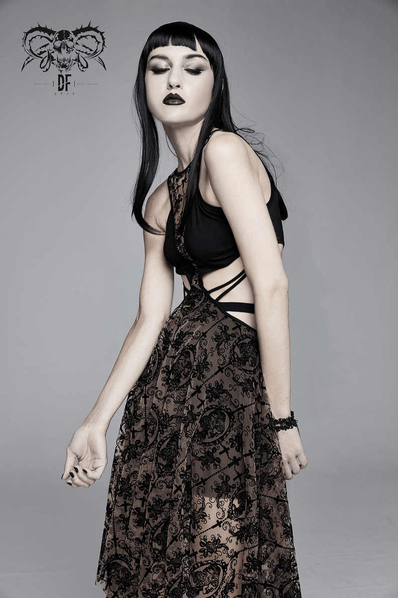 Model showcasing a women's gothic vintage dress with intricate patterns and asymmetrical cut.