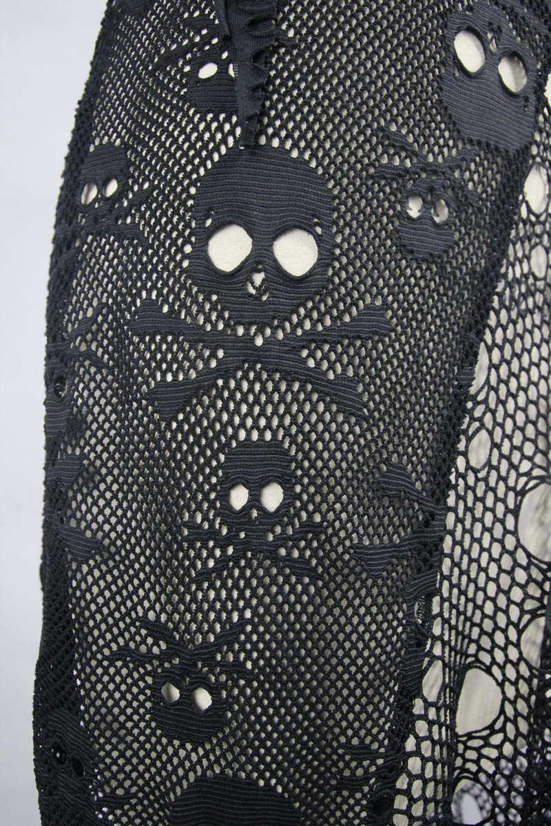 Close-up of gothic mesh fabric with skull and crossbones pattern for women's sleeveless maxi dress.