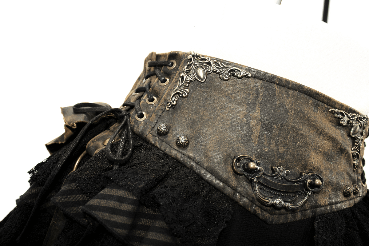 Close-up of a steampunk brown mini skirt with intricate lace and faux leather details, showcasing a vintage-inspired design.