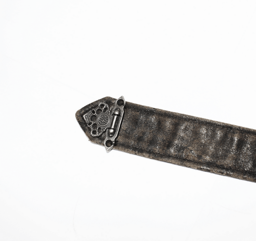 Close-up of a steampunk style mini skirt buckle with intricate design and faux leather strap.