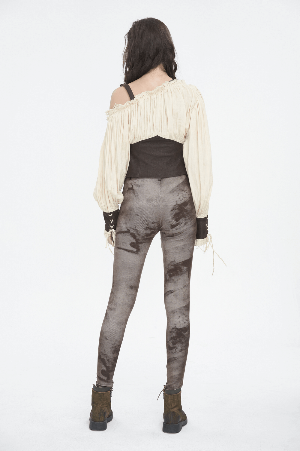 Back view of a woman wearing Victorian-inspired steampunk leggings and an elegant off-shoulder top.