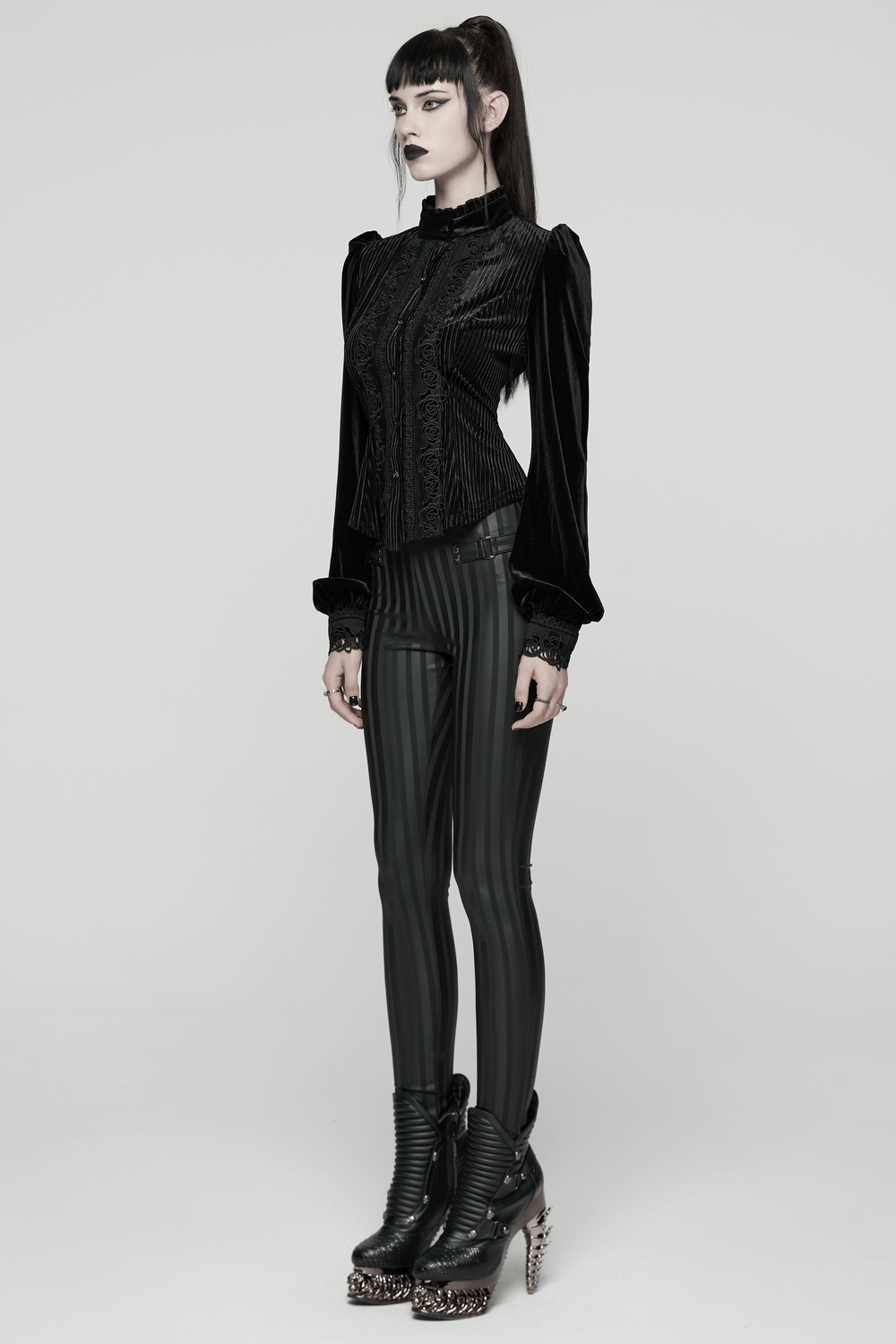 Women's Striped Leggings with Buckle Straps and Pockets paired with a gothic top and edgy boots.