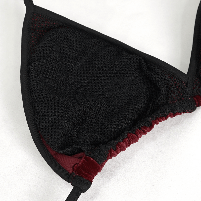 Close-up of the interior of a women's wine red velvet bikini top with a black mesh lining.