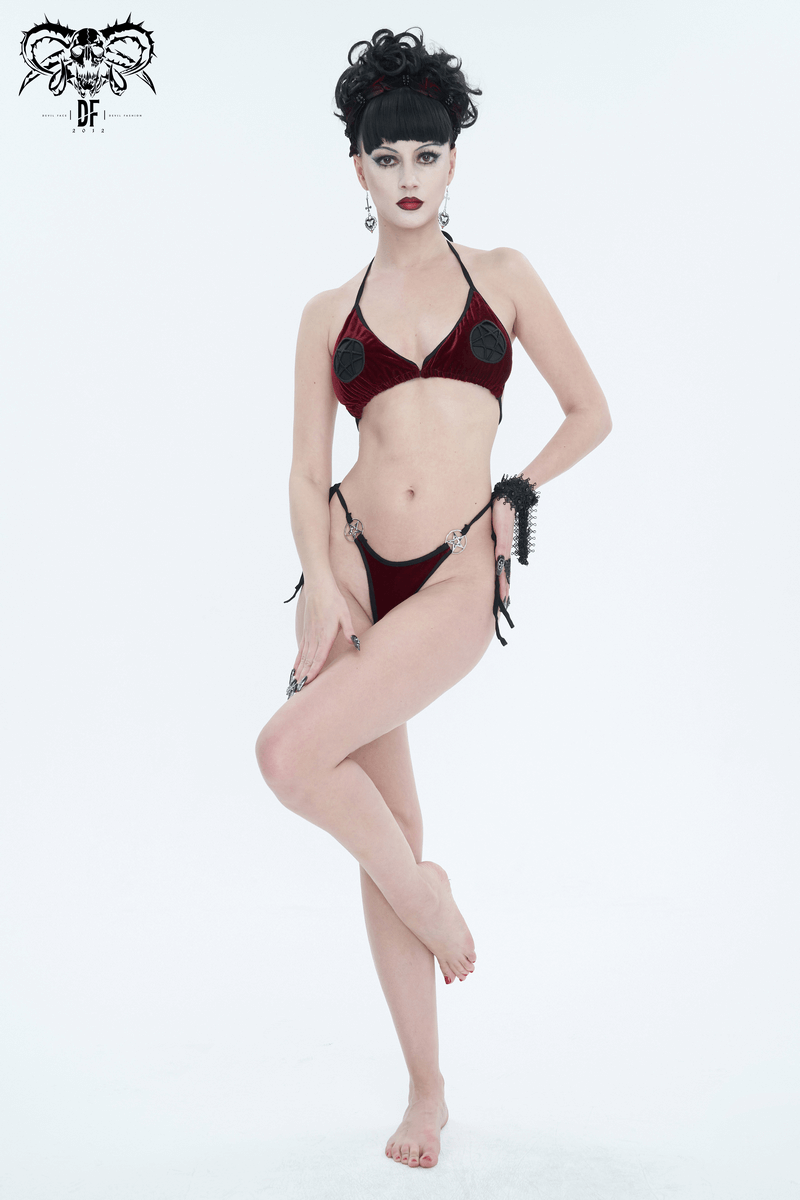Stylish woman in wine red velvet bikini with pentagrams, showcasing alternative beachwear fashion.