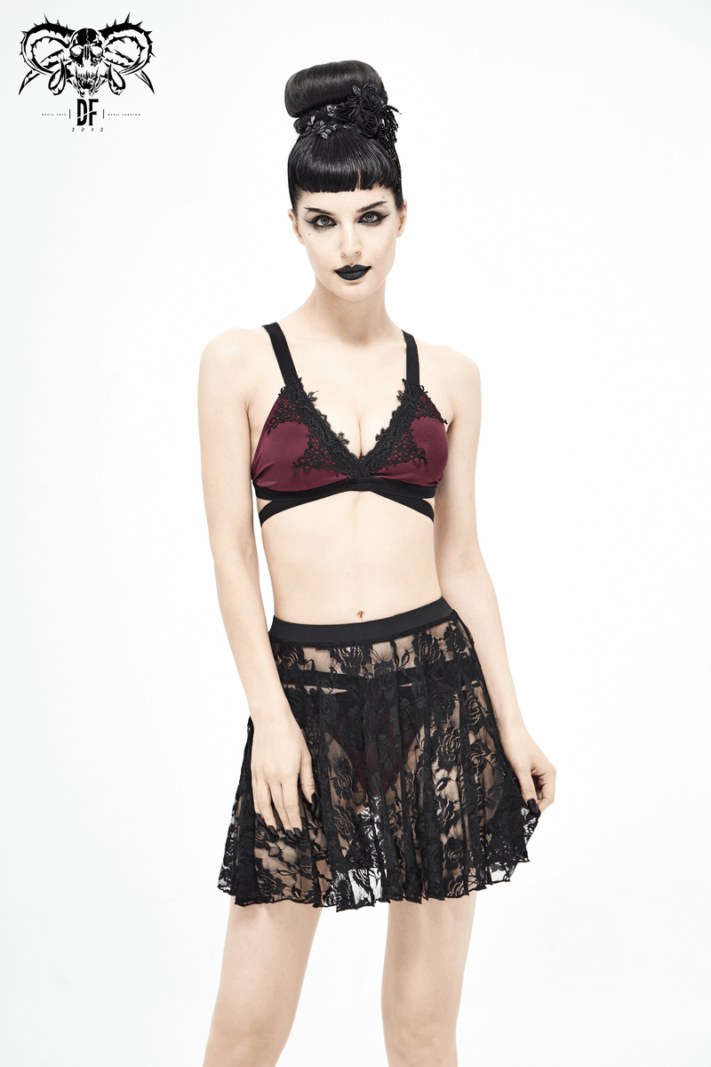 Model showcasing a women's black floral lace mini skirt paired with a stylish bralette in a gothic fashion setting.