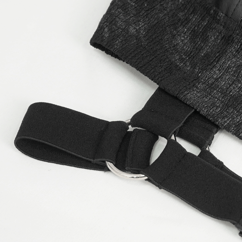 Close-up of black cutout collar with studded straps, showcasing edgy punk chic design.