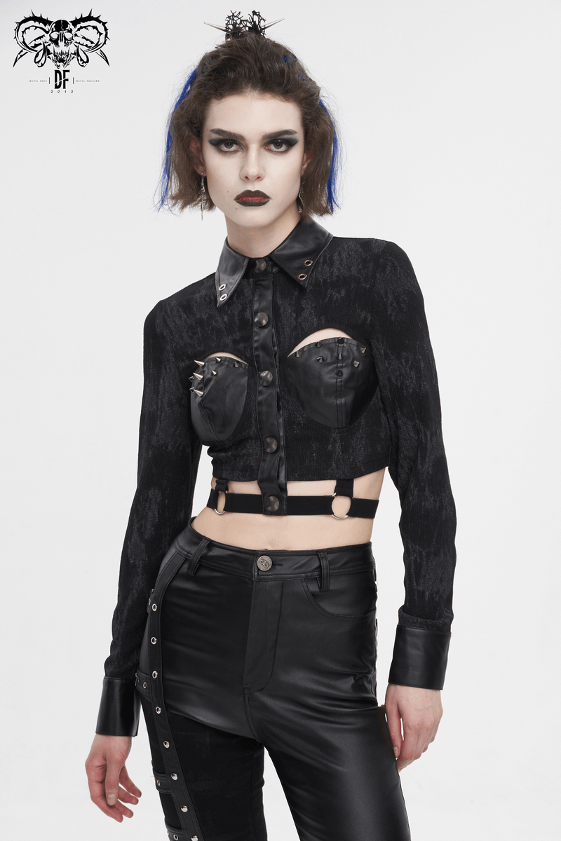 Women's punk-style black cutout shirt with studded details and cropped design, embodying edgy chic fashion.