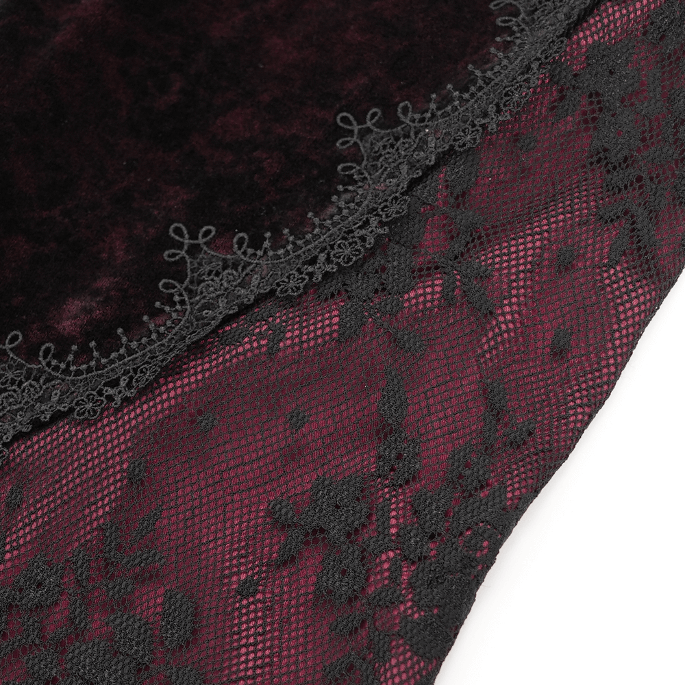 Close-up of women's velvet flare pants featuring intricate black lace and embroidery details on dark fabric.