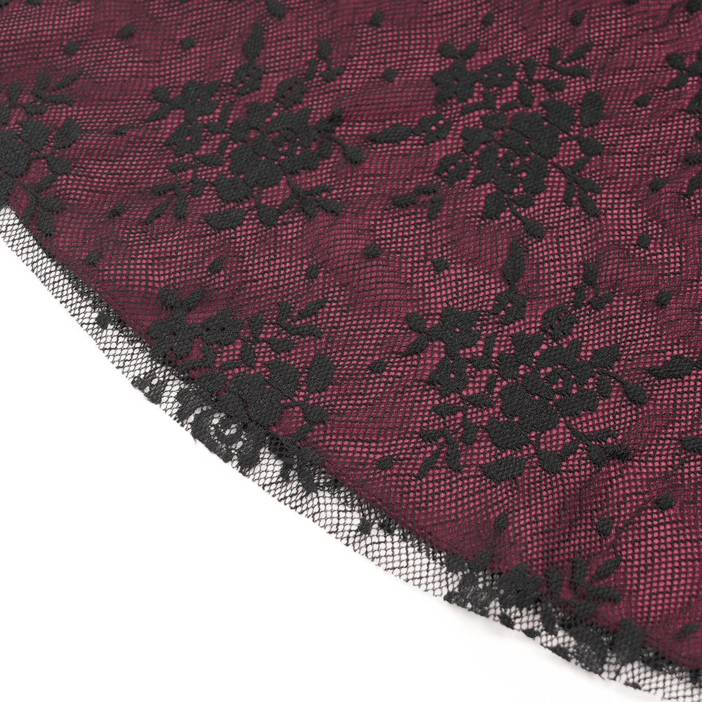 Close-up of sheer black lace with floral patterns, perfect for dark boho bell bottoms and gothic fashion.