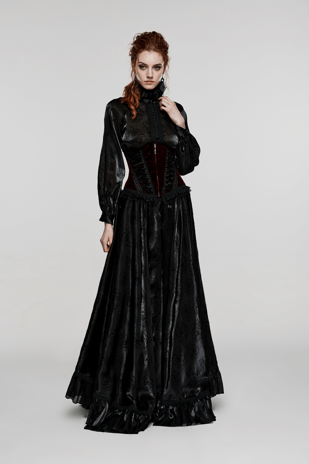 Gothic women's velvet corset with lace accents, paired with a long black skirt in a darkly romantic style.