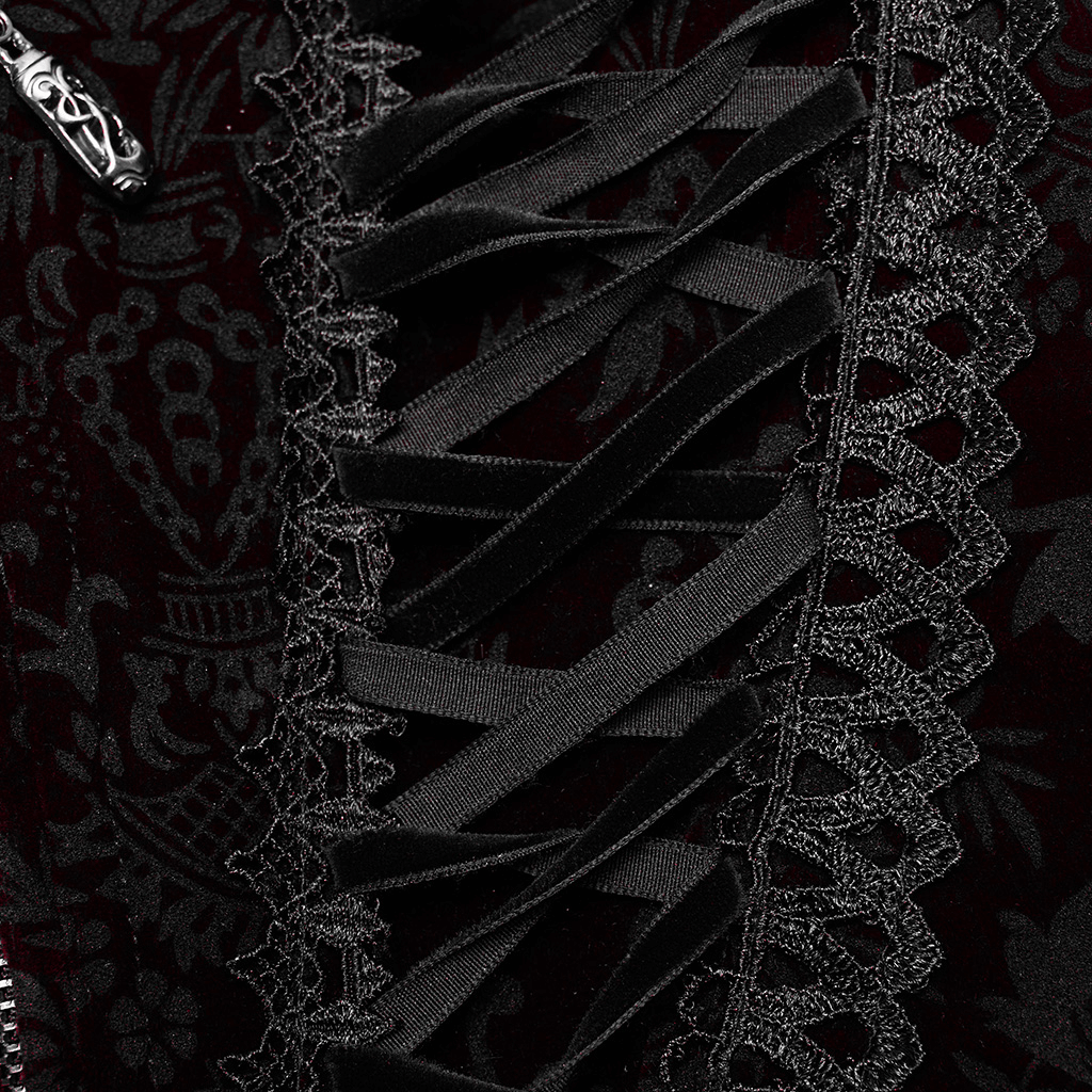 Close-up of intricate lace accents and ribbon ties on a women's velvet gothic corset in dark romantic style.