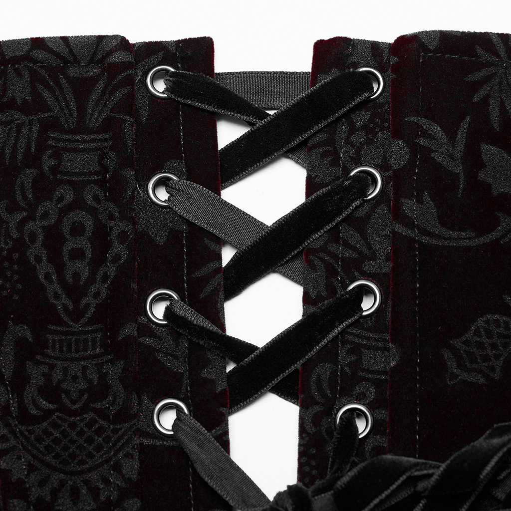 Close-up of a women's velvet gothic corset showing lace accents and tie-back details, highlighting vintage allure.