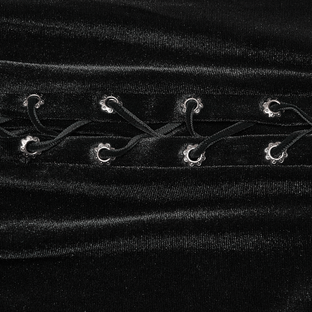 Detail of black velvet fabric featuring drawstrings with decorative silver buckles for goth style skirt.