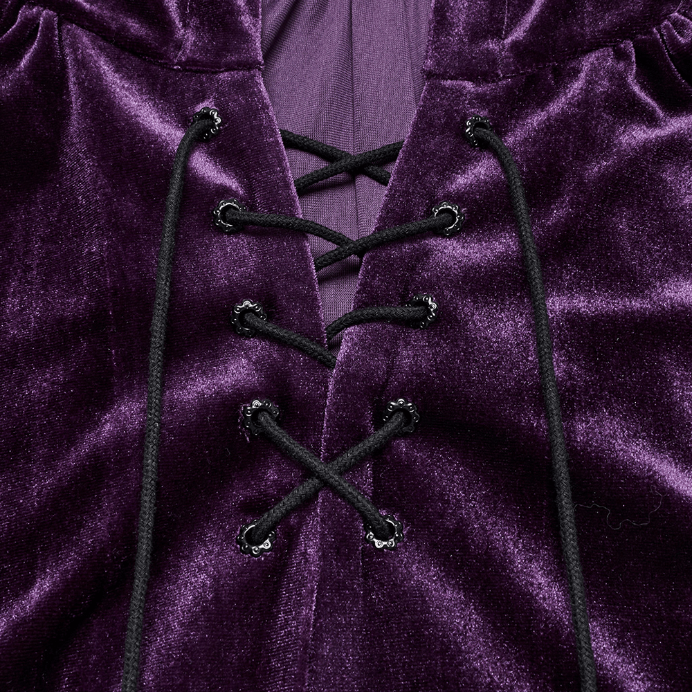 Close-up of the drawstring front on a purple women's velvet hooded cape with fur ball ties.