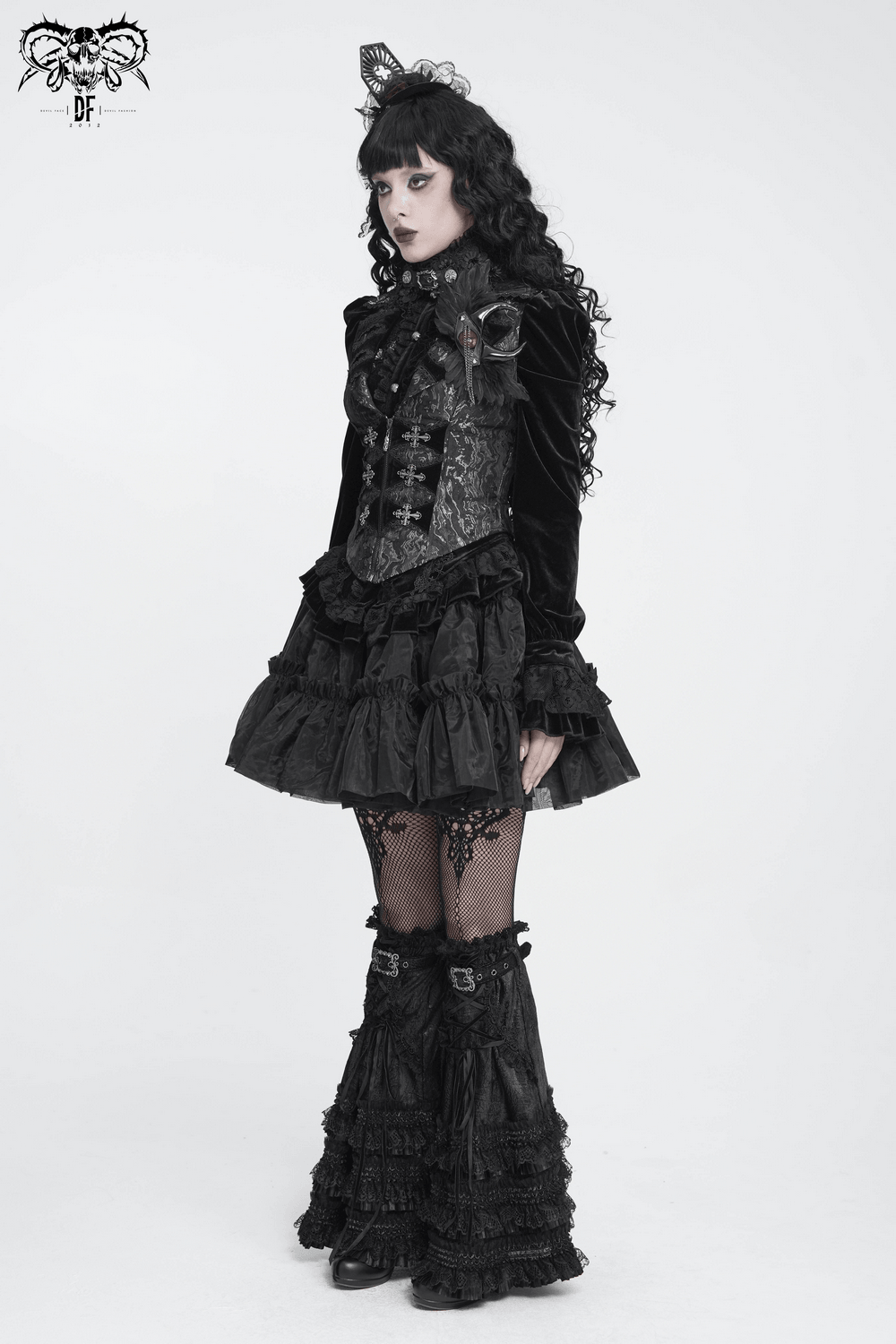 Women's Victorian Brocade Waistcoat with Cross Details worn by a model in dark goth style, featuring fitted waist and dramatic tails.