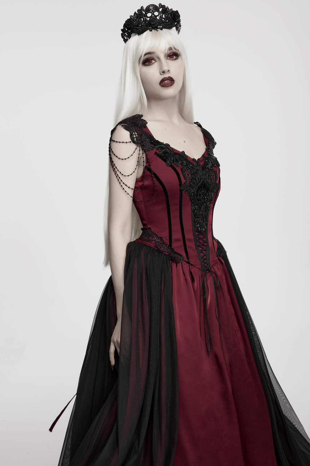 Model wearing Women's Victorian Gothic Lace and Velvet Dress with corset and black mesh skirt.