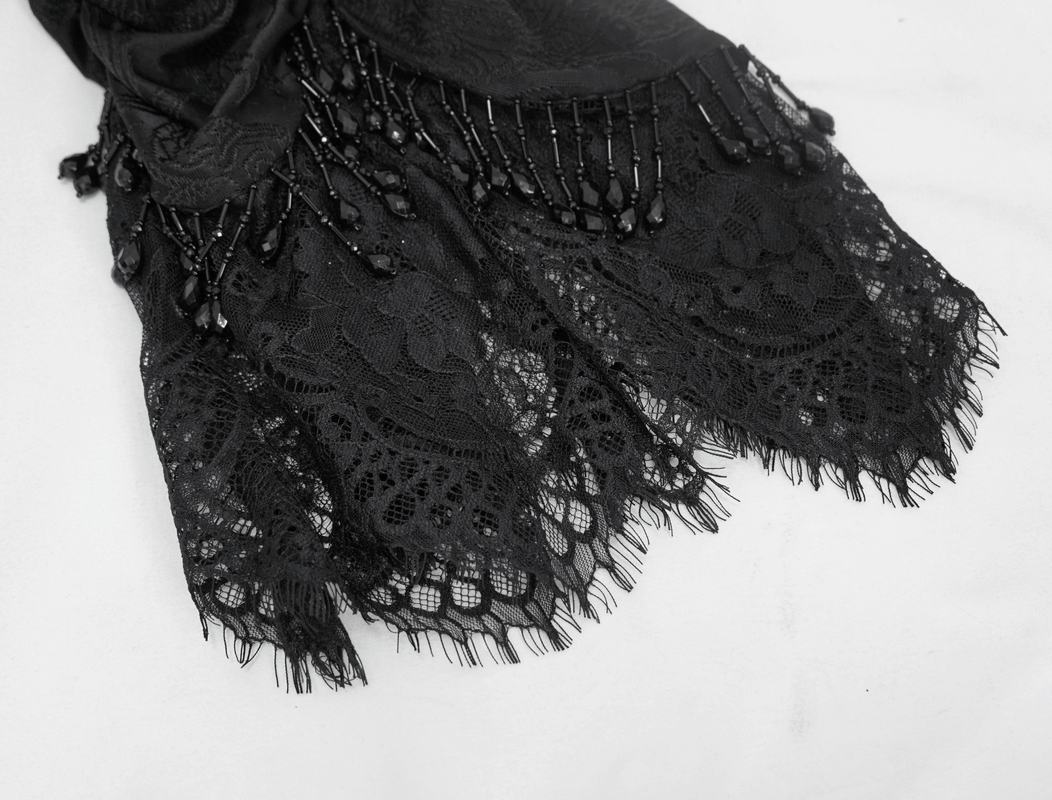 Elegant black lace trim with intricate detailing and decorative beads, perfect for gothic or vintage style outfits.