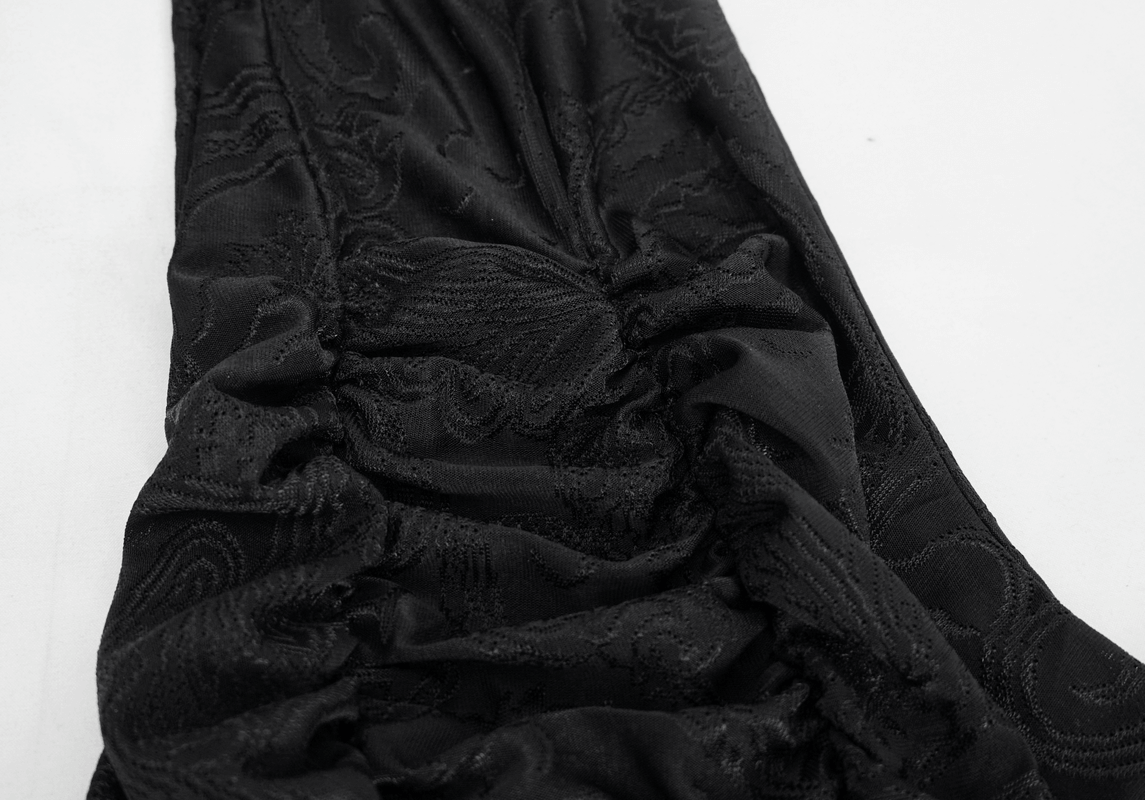 Close-up of women's vintage gothic black flared trousers with lace trim, showcasing elegant fabric texture.