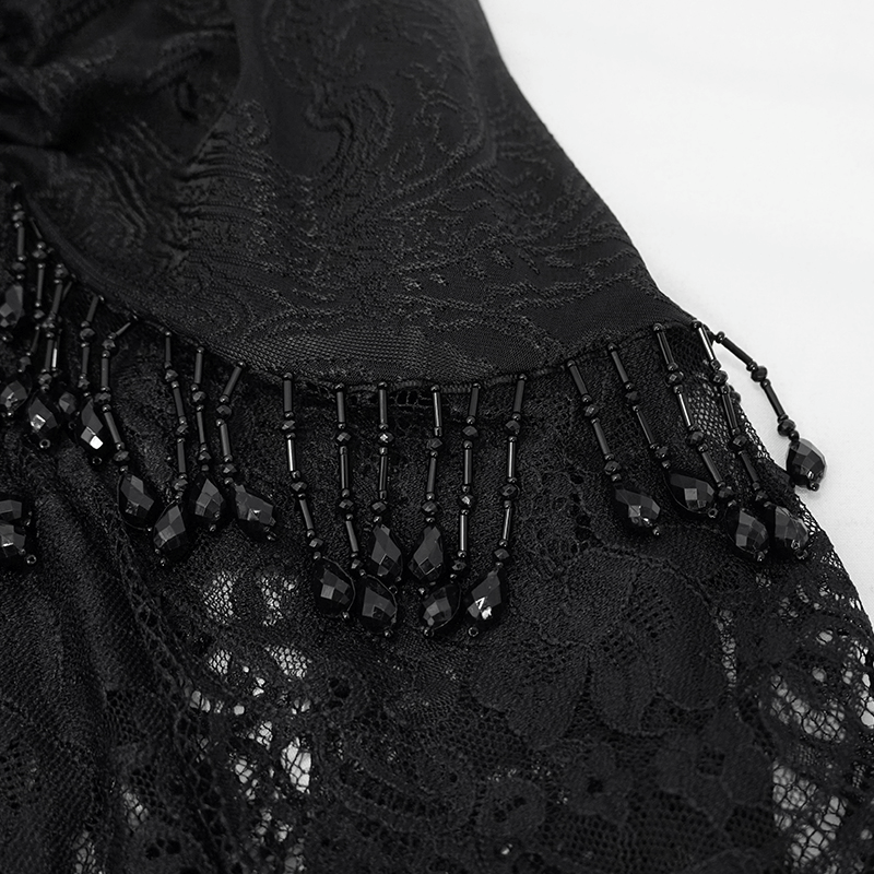 Close-up of women's black lace flared trousers with intricate beaded lace trim, perfect for a gothic style outfit.