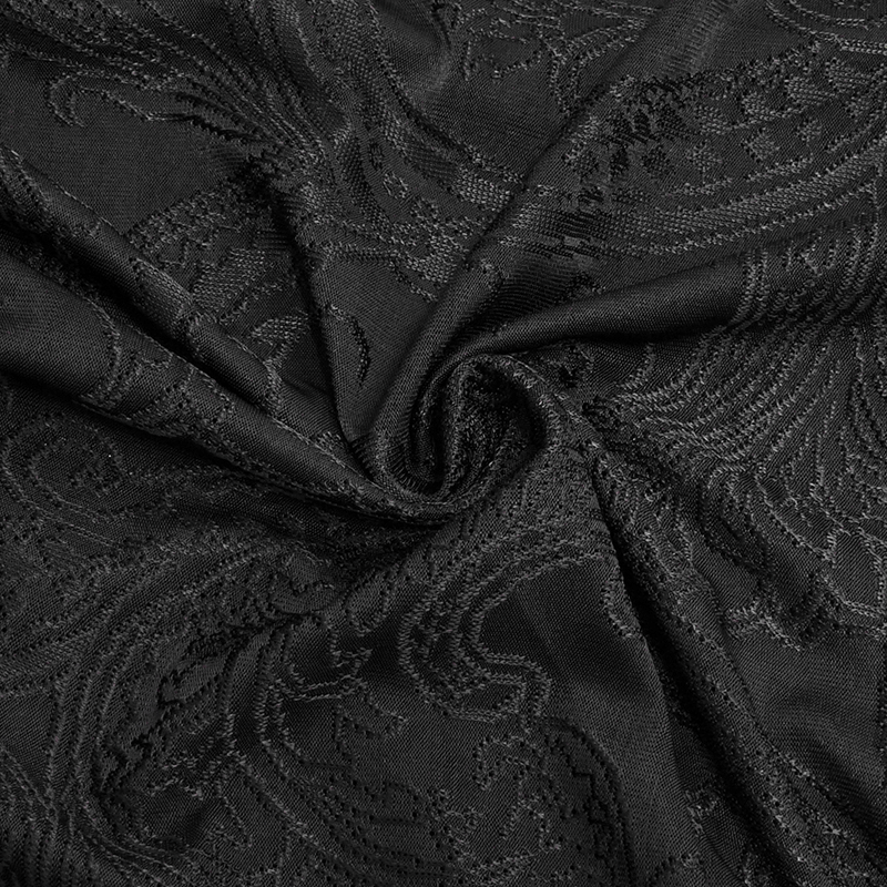 Close-up of luxurious black lace fabric showcasing intricate patterns, perfect for gothic-inspired fashion.