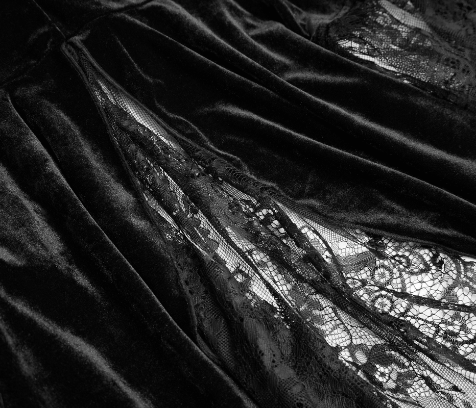 Close-up of women's vintage gothic black velvet cape with delicate lace inserts.