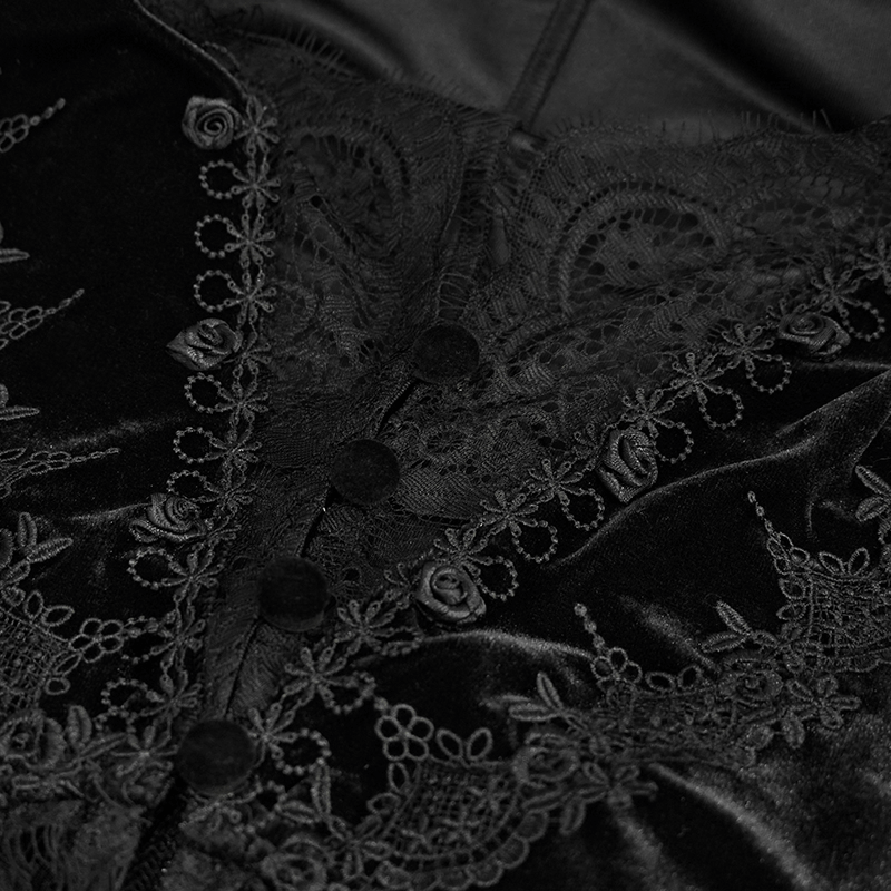 Close-up of women's black velvet cape with intricate lace detailing and buttons, showcasing gothic vintage style.