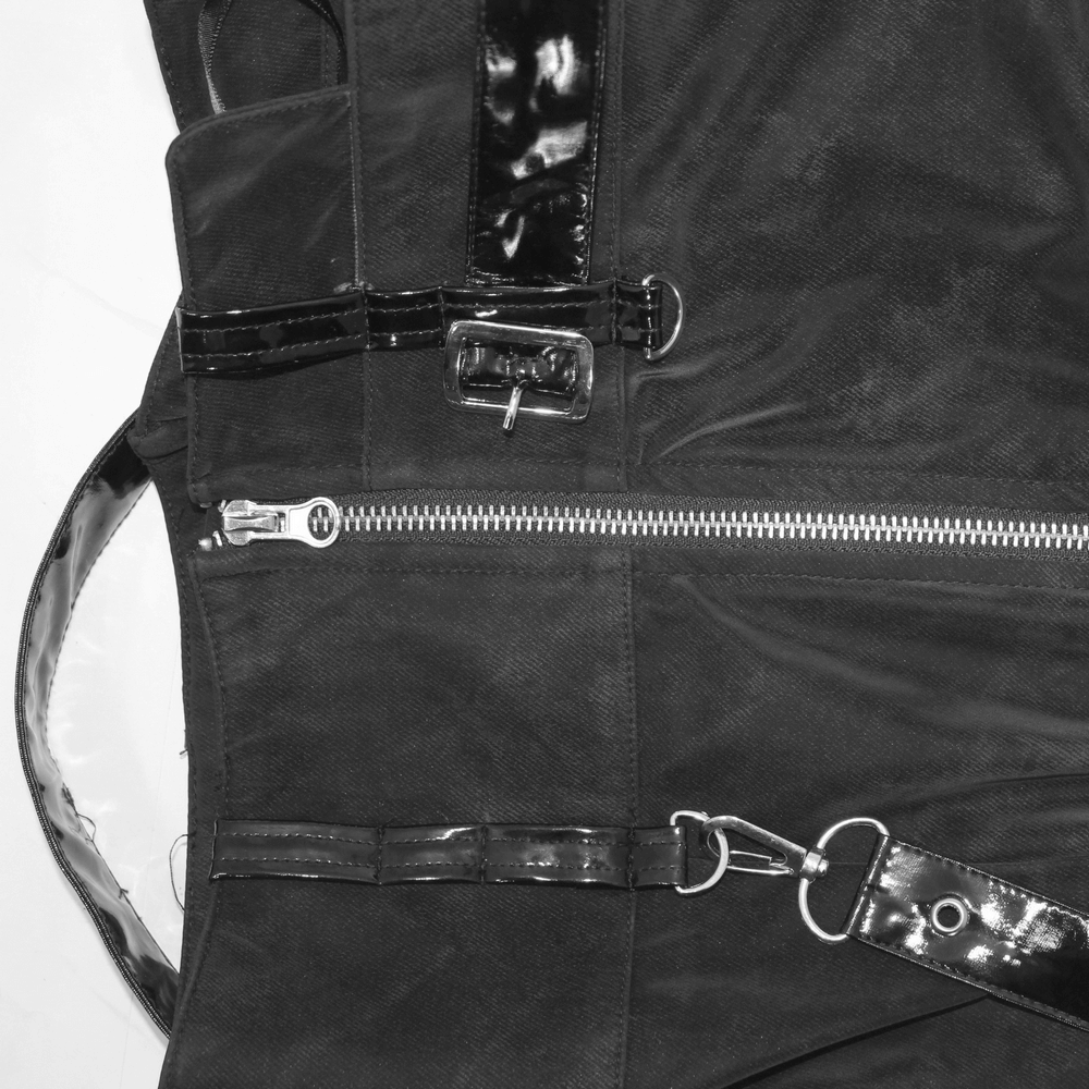 Close-up of black vintage long skirt featuring rivets, buckles, and zipper details for steampunk fashion lovers.