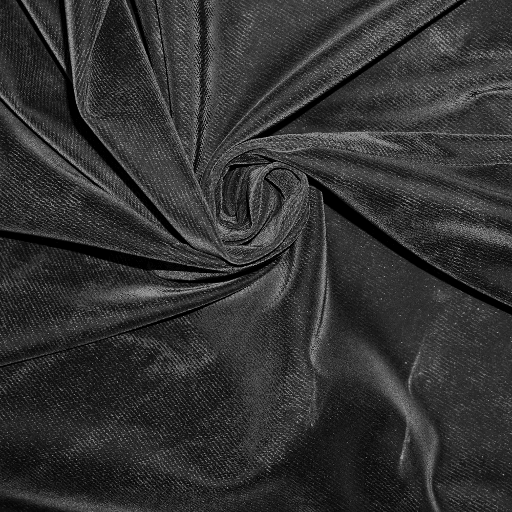 Close-up of black fabric swirl, perfect for vintage long skirts and gothic apparel.
