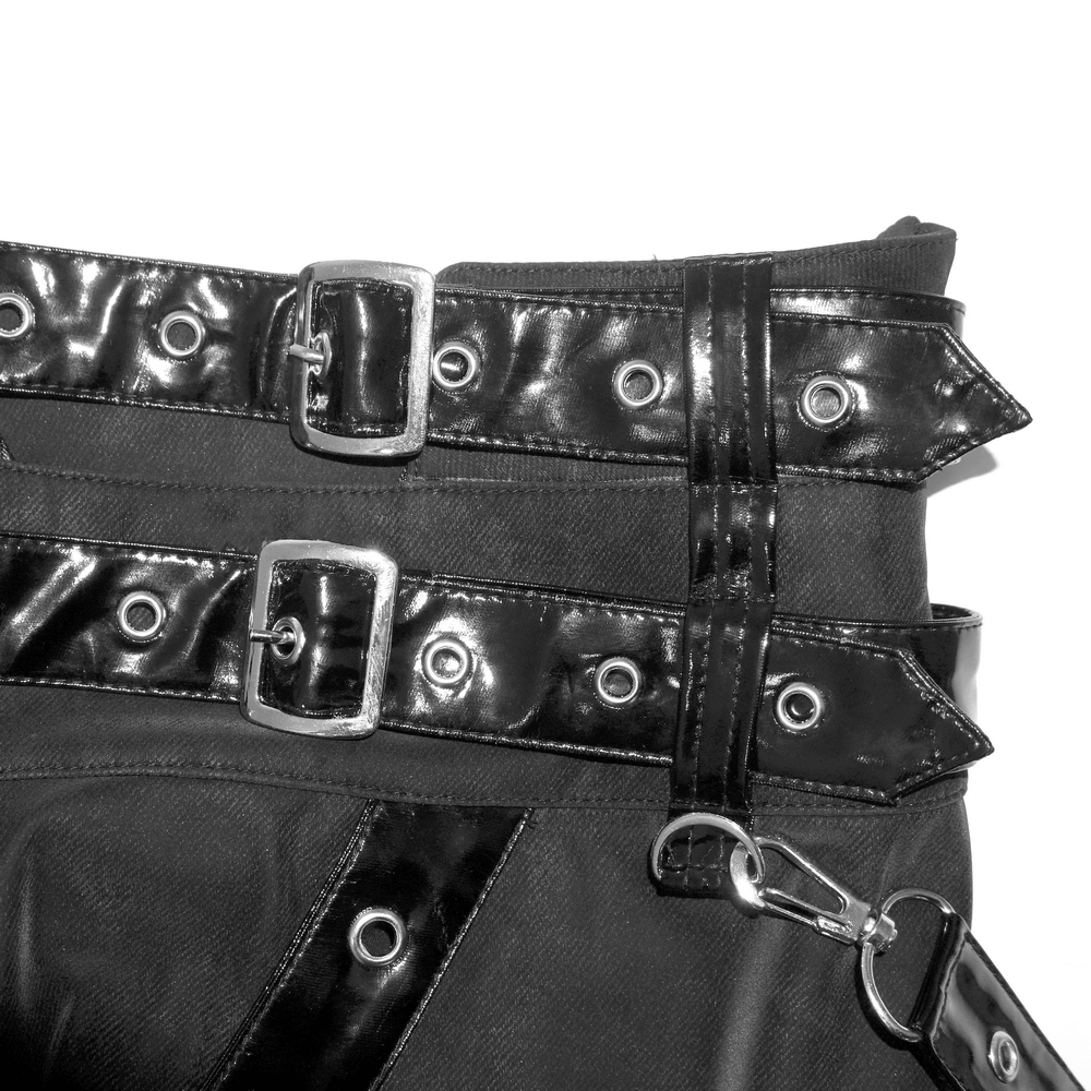 Close-up of black straps and rivets on a vintage long skirt, showcasing steampunk and punk fashion elements.