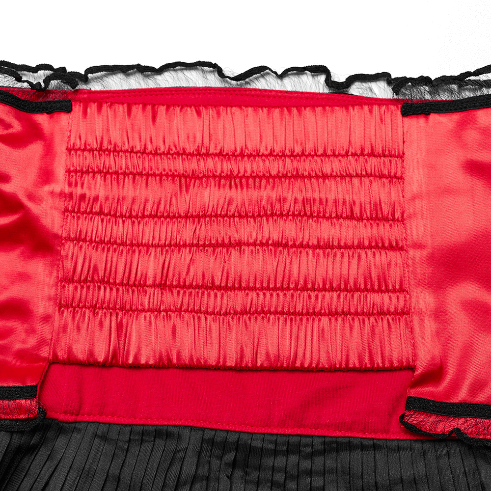 Close-up of the red smocked interior detail of a kimono set showcasing elastic design and contrasting black fabric.