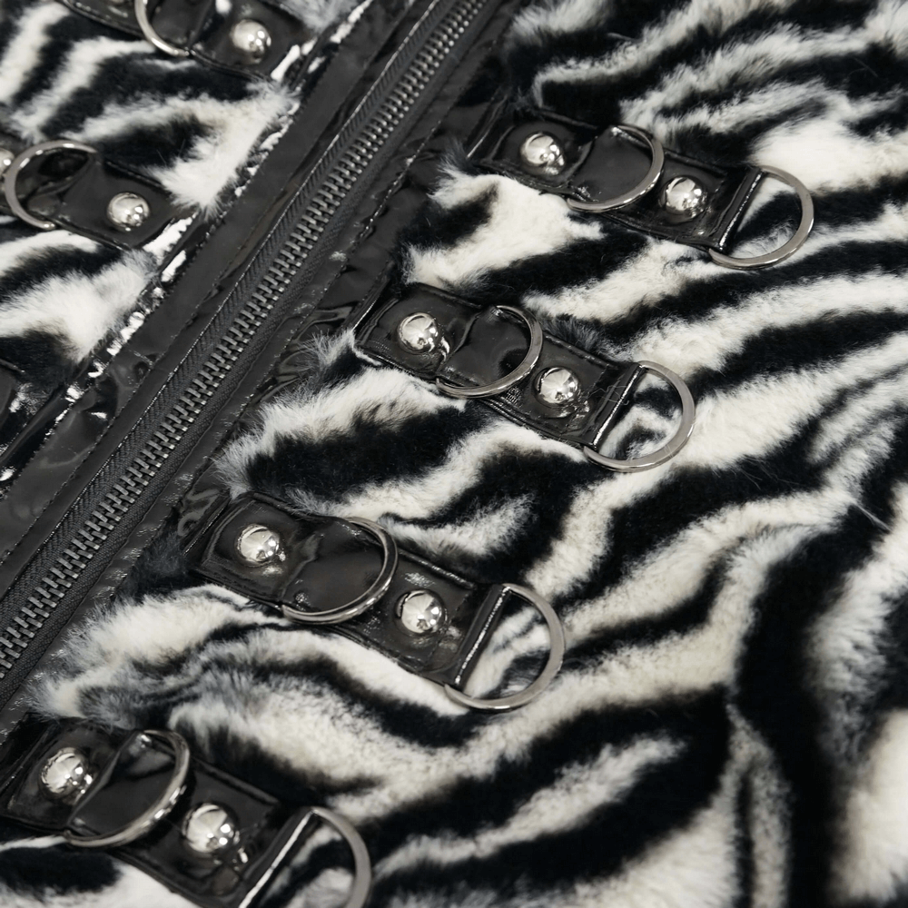 Close-up of women's zebra-striped faux fur jacket with zip and decorative buckles.