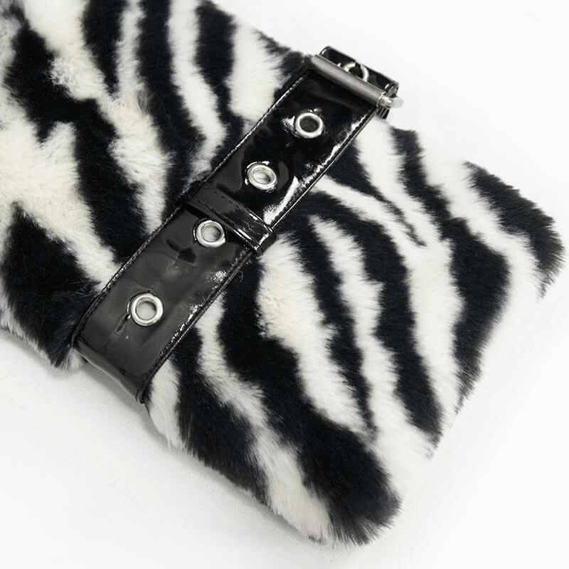 Close-up of women's zebra-stripe faux fur jacket with stylish black buckle detail.